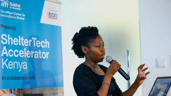 A participant of ShelterTech Accelerator Kenya speaks into a microphone.