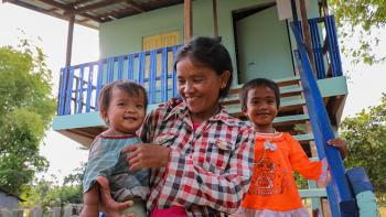 Han and her children in front of their home completed during Cambodia Big Build 2019.