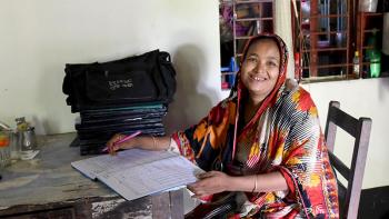 Habitat homeowner Sakina catching up on work at home in Bangladesh