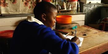 Girl doing homework at her desk in Lesotho