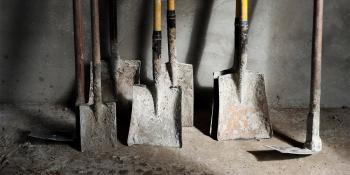 Shovels leaning against a wall