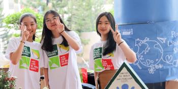 Students from a Habitat school club in Vietnam man a charity booth to raise money for Habitat Vietnam for its Habitat Young Leaders Build campaign