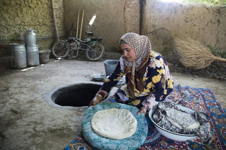 woman preparing food in Tajikistan