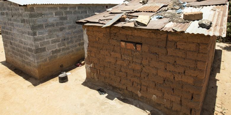Photo: two structures - one from cement block and one from mud bricks
