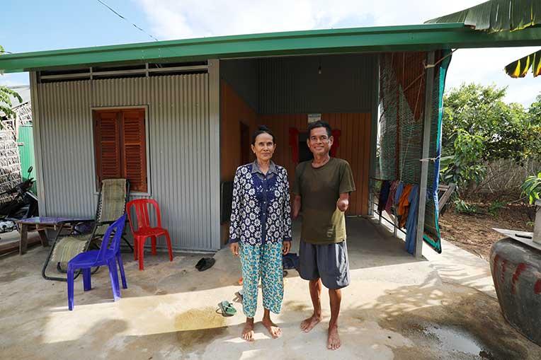 Samuth and her husband Bunthoeun in front of their house in cambodia's Kandal province