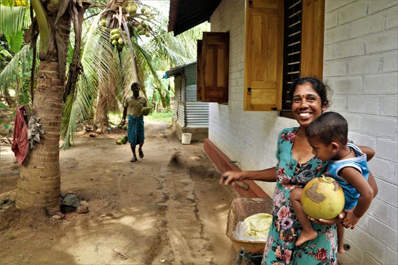 Jeyathini with her family and the coconuts they harvest in Sri Lanka