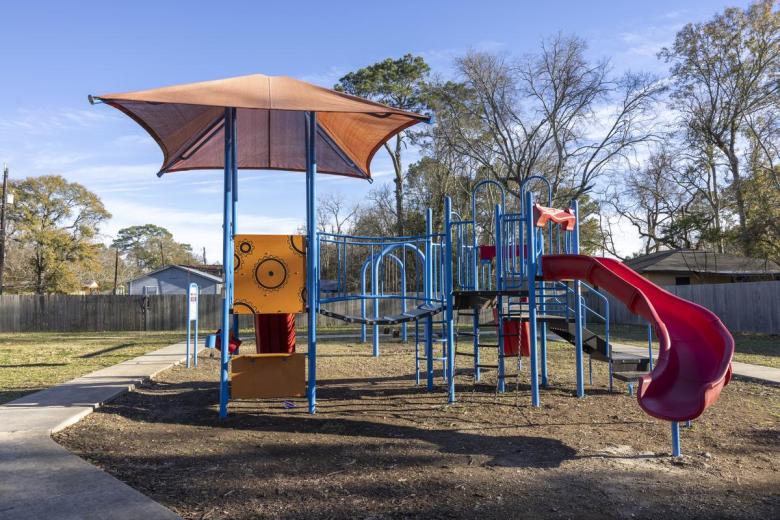 McComb-Veazey's pocket park, which includes a playground set and swings.