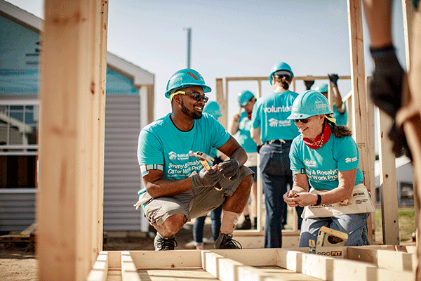 Andrew Herbst and Kenneth Echols Jr chat at the 2018 Habitat for Humanity Jimmy and Rosalynn Carter Work Project in St. Joseph County, Indiana.