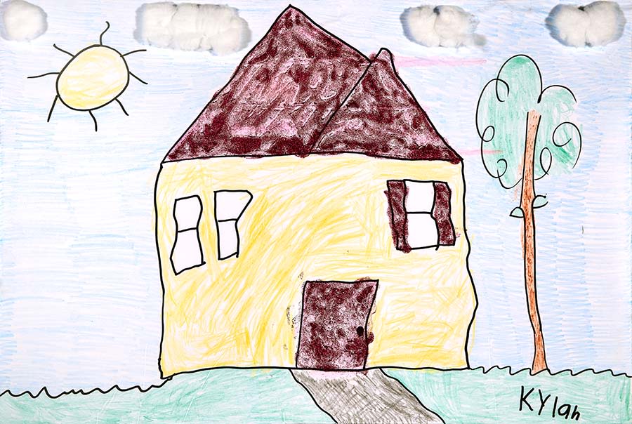 Marker and crayon drawing of Kylan's house, a yellow two-story home with a tree and front pathway. Above the house are a bright sun and cotton-ball clouds.