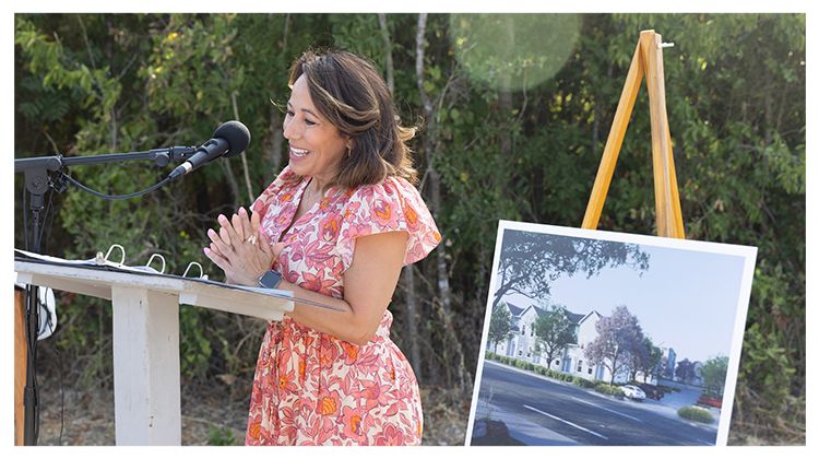 A speaker announces the future Persimmon Point development at an event, with a rendering on an easel next to her.