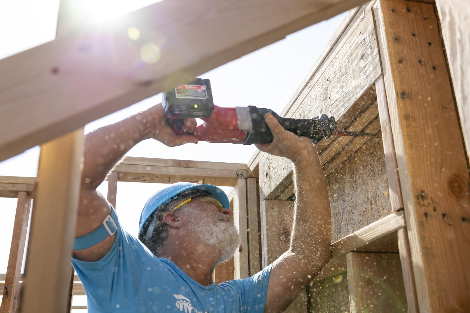 A volunteer uses power tools to help build during the Jimmy and Rosalynn Carter Work Project in Austin, Texas.