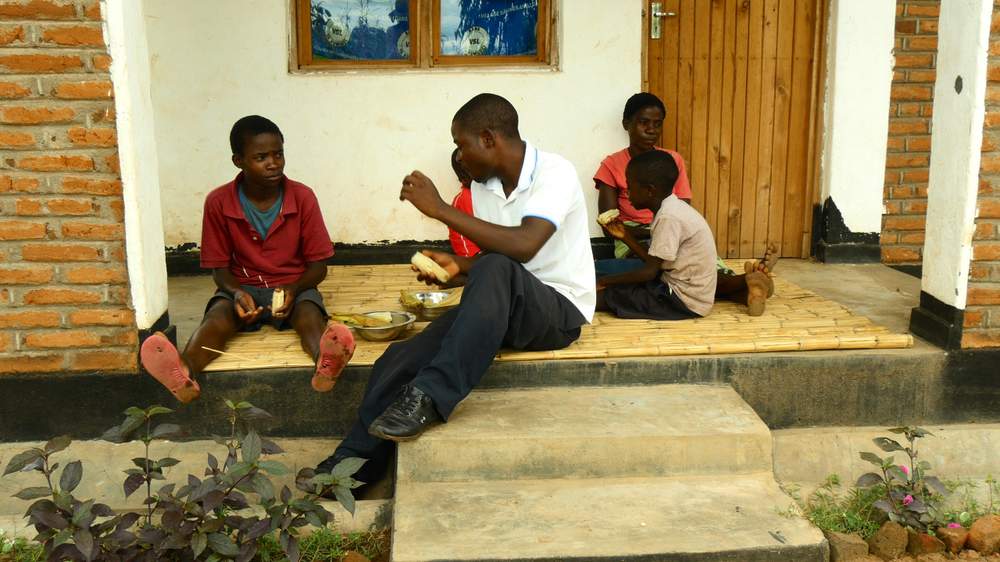 Bertha&#39;s family relaxing on a porch of their new home.