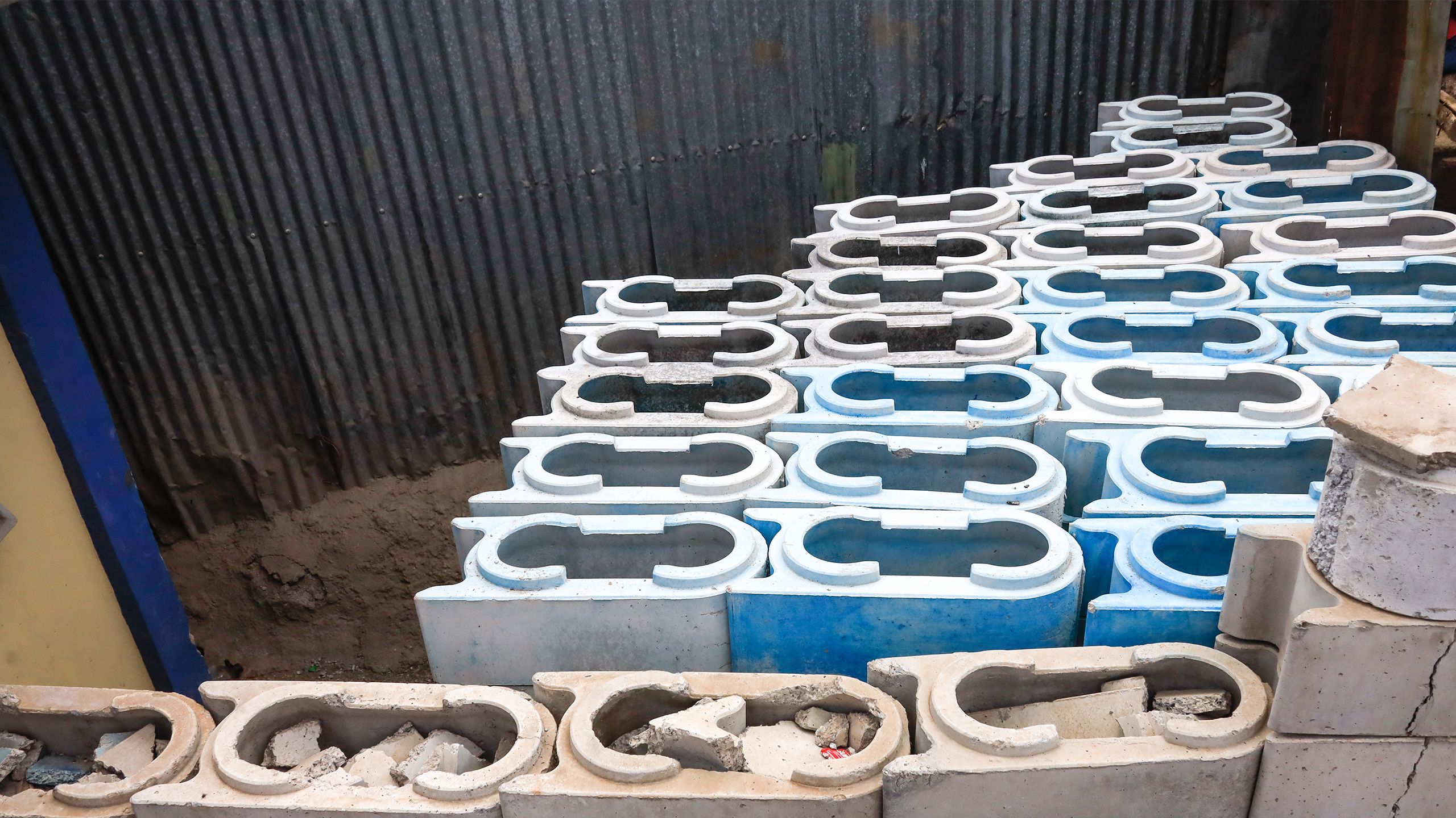 A stack of completed gray and blue TwistBlocks, showing the interlocking shape.