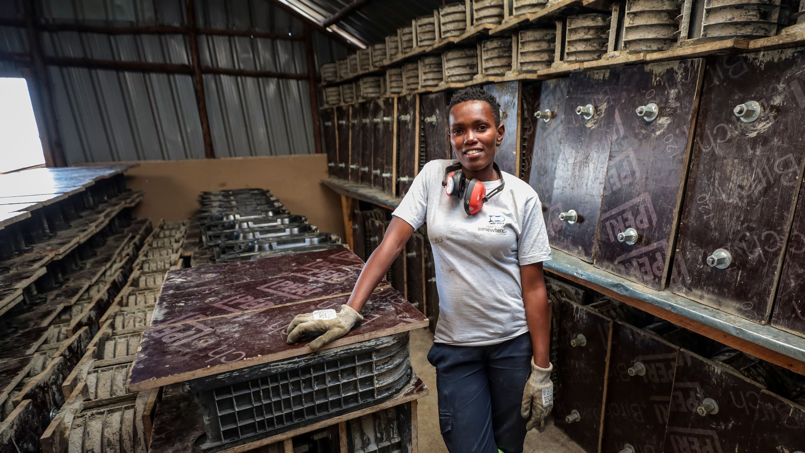 Milka stands in the Start Somewhere workshop, surrounded by concrete molds.