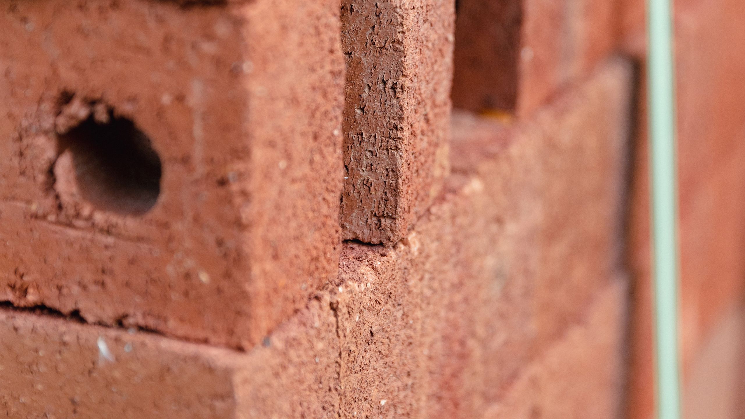Closeup of a neat stack of red bricks waiting for use.