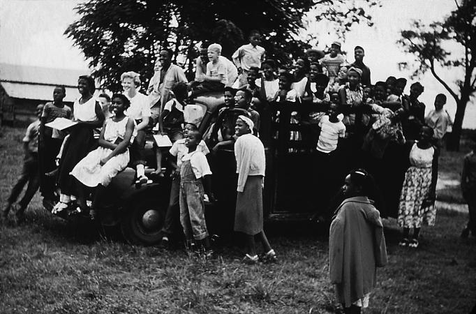 Black and white photo of a group of children on a truck at the Koinonia Farm.