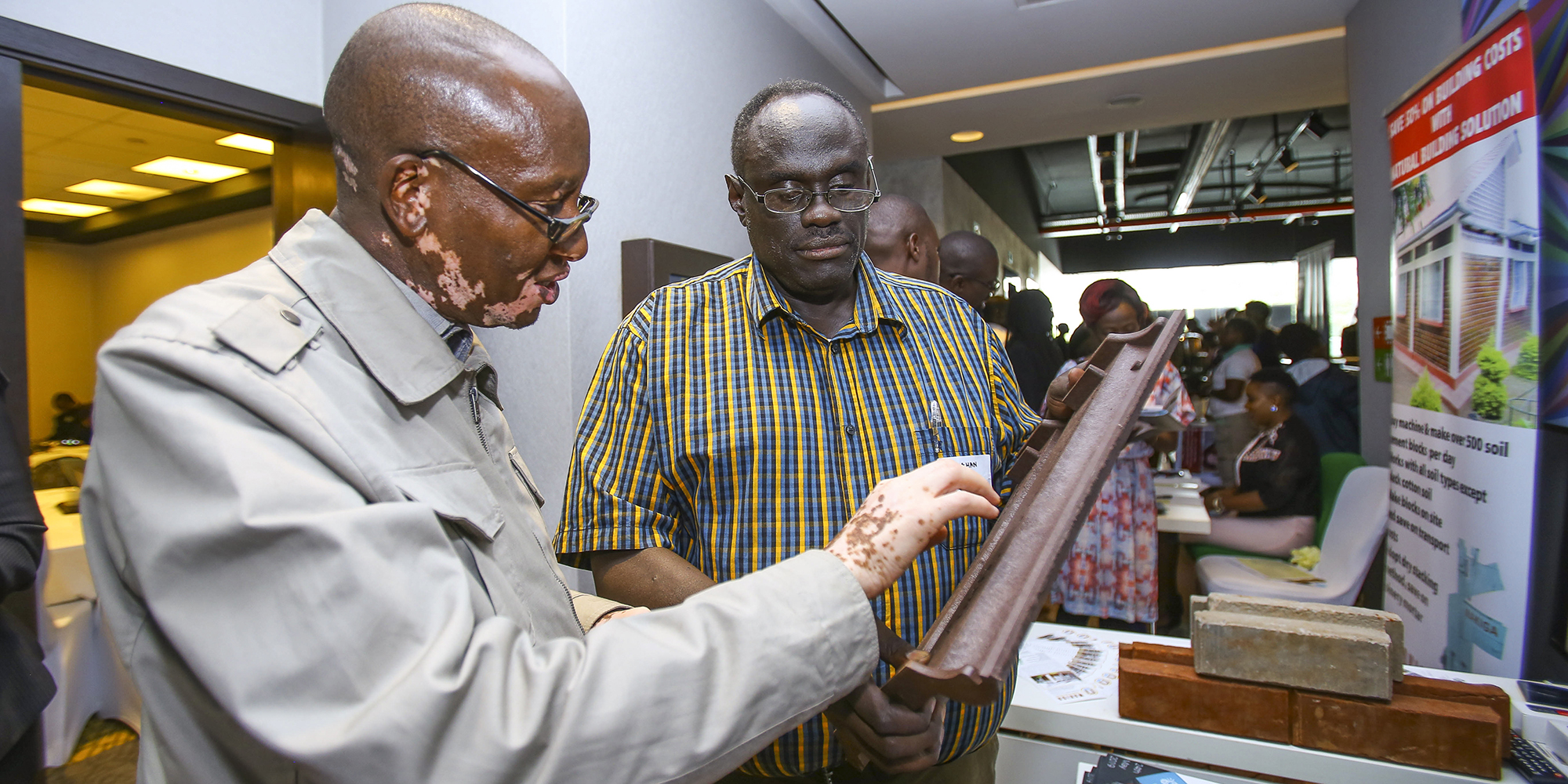 Two participants at an accelerator look at a clipboard together.