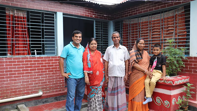 Ashish and his family outside their home in Mymensingh, Bangladesh.
