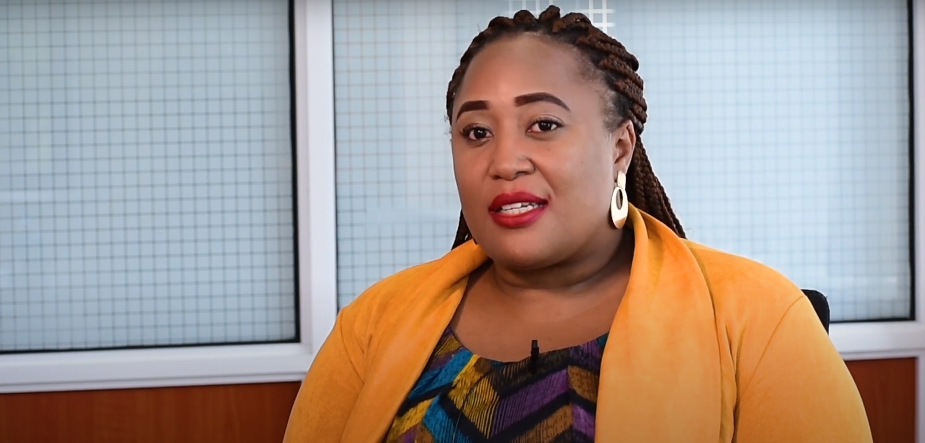 A woman in a yellow cardigan during an interview about the ShelterTech Africa launch.