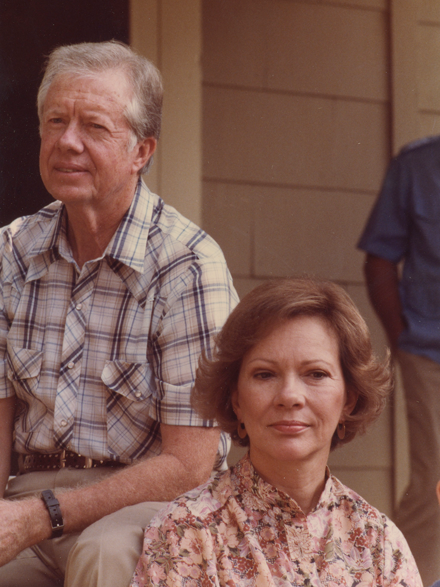 A portrait of The Carters in 1984; they're sitting on a porch together, at-ease.