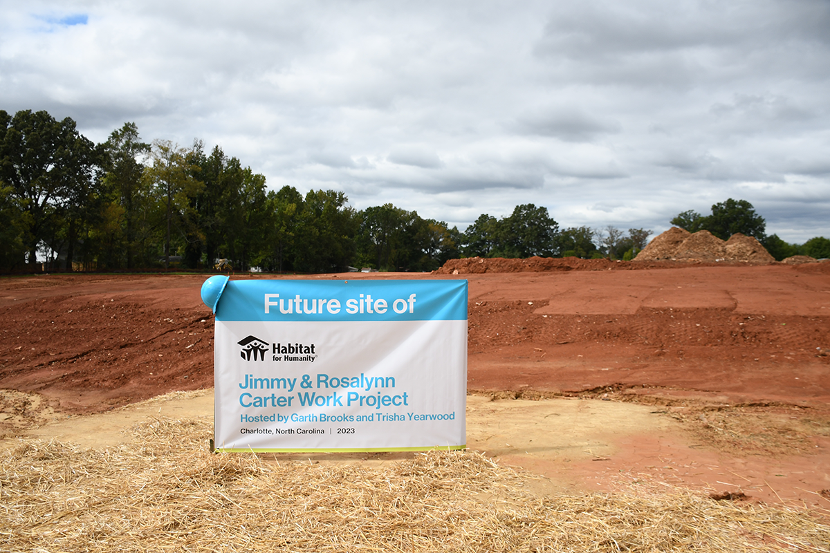 Carter Work Project banner on empty plot that has been prepared for construction