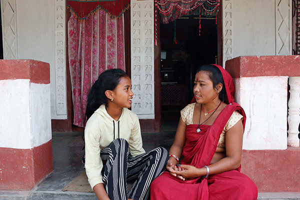 Shanti and her daughter in front of their house in Morang District, Nepal. After taking a home construction loan from JBLBSL, she was able to build a new house, as well as a livestock shed to increase her income.