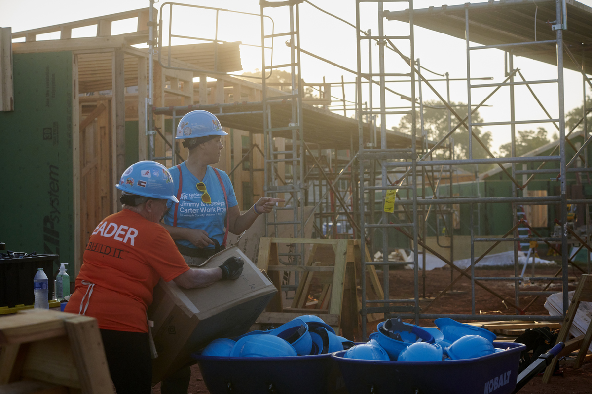 Two volunteers on the build site in the early morning