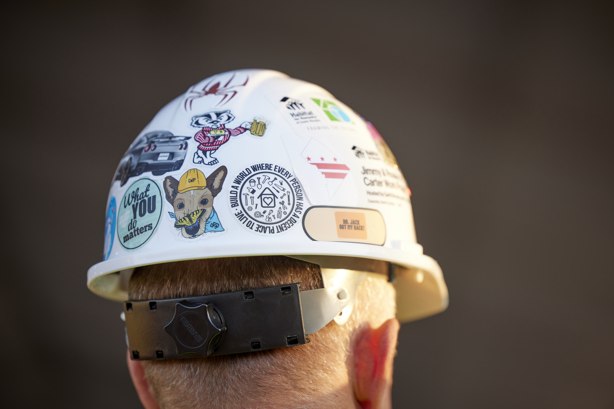 Back of volunteer's hardhat bearing a collection of stickers