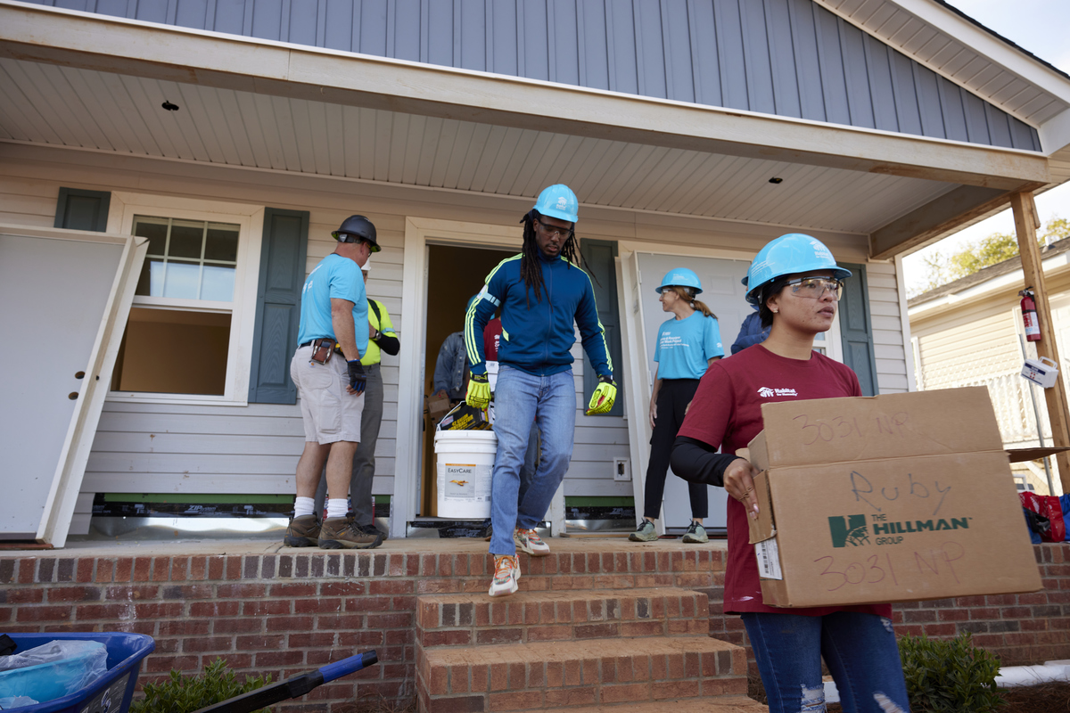 Future homeowner and volunteers working on Habitat house