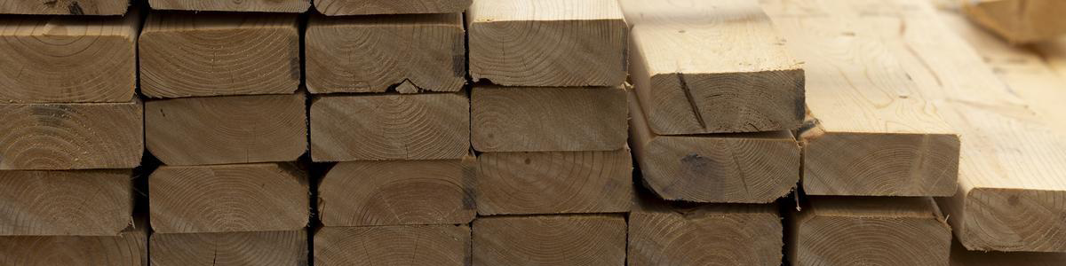Close-up of stacked two-by-fours in the lumber section of a ReStore.