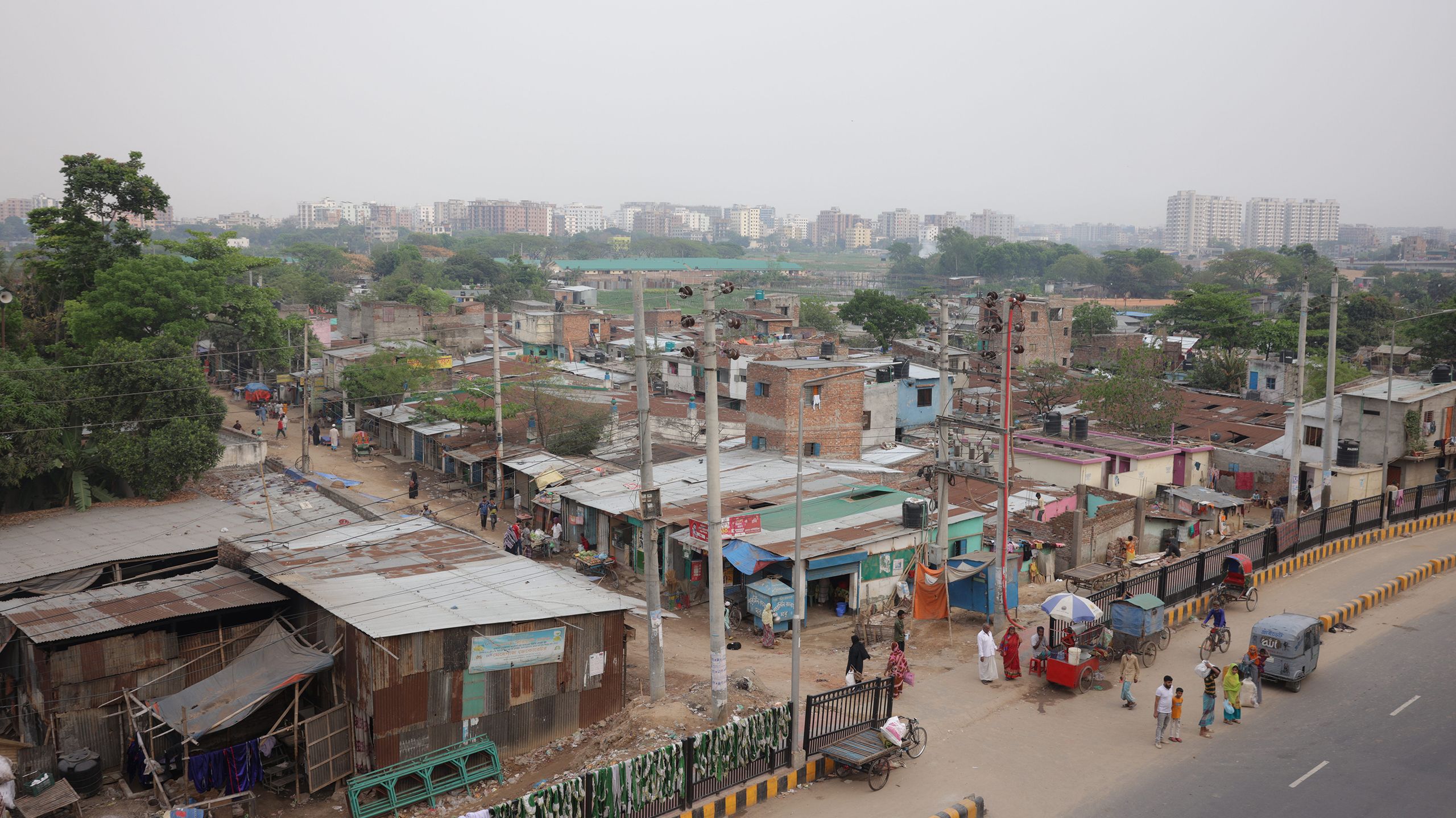 Bird's eye view of closely packed, roughly built homes and shops stretching into the distance.