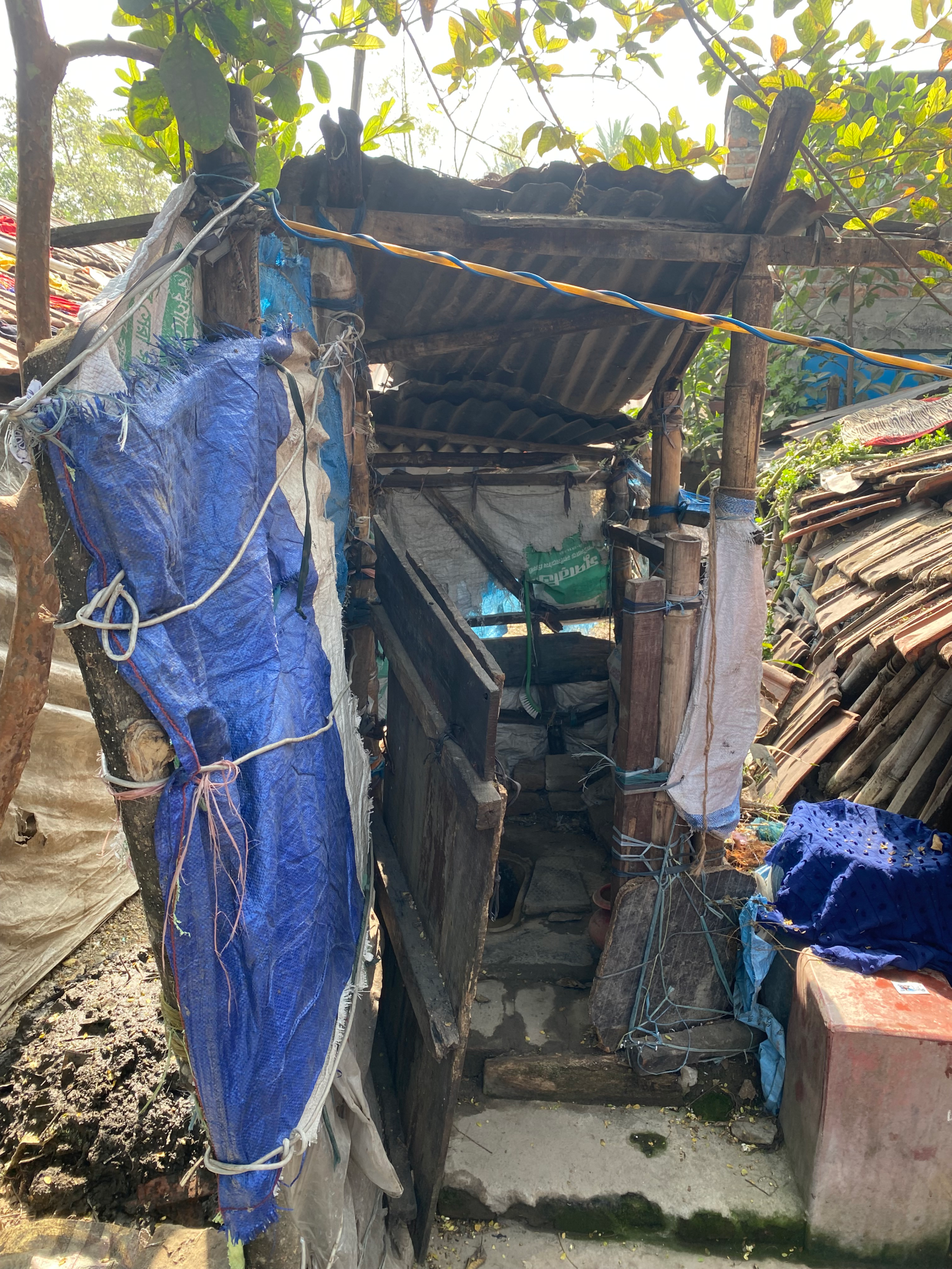 Outhouse made from found materials in an informal settlement in Satkhira, Bangladesh. 