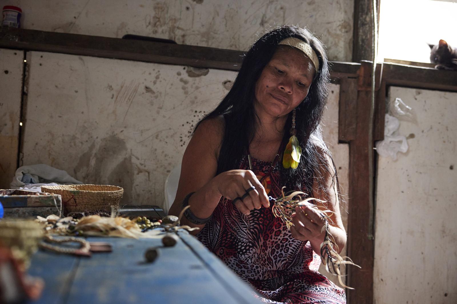 Lutana Ribeiro shows some of the handmade jewelry she makes and sells for extra income.