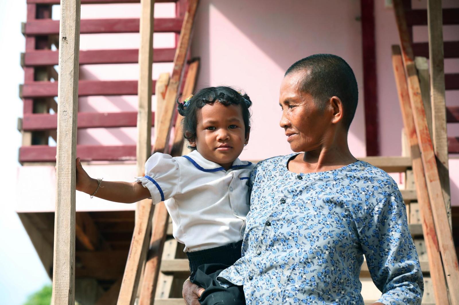 Lem poses fora portrait with her grand daughter, Chanya, at their house in Siem Reap, Cambodia.