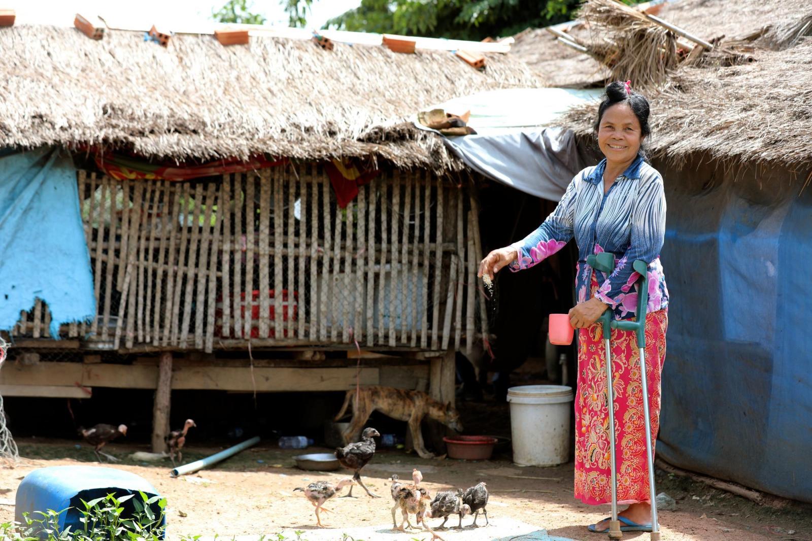 Rem feeds her chickens at her home in Battambang, Cambodia.