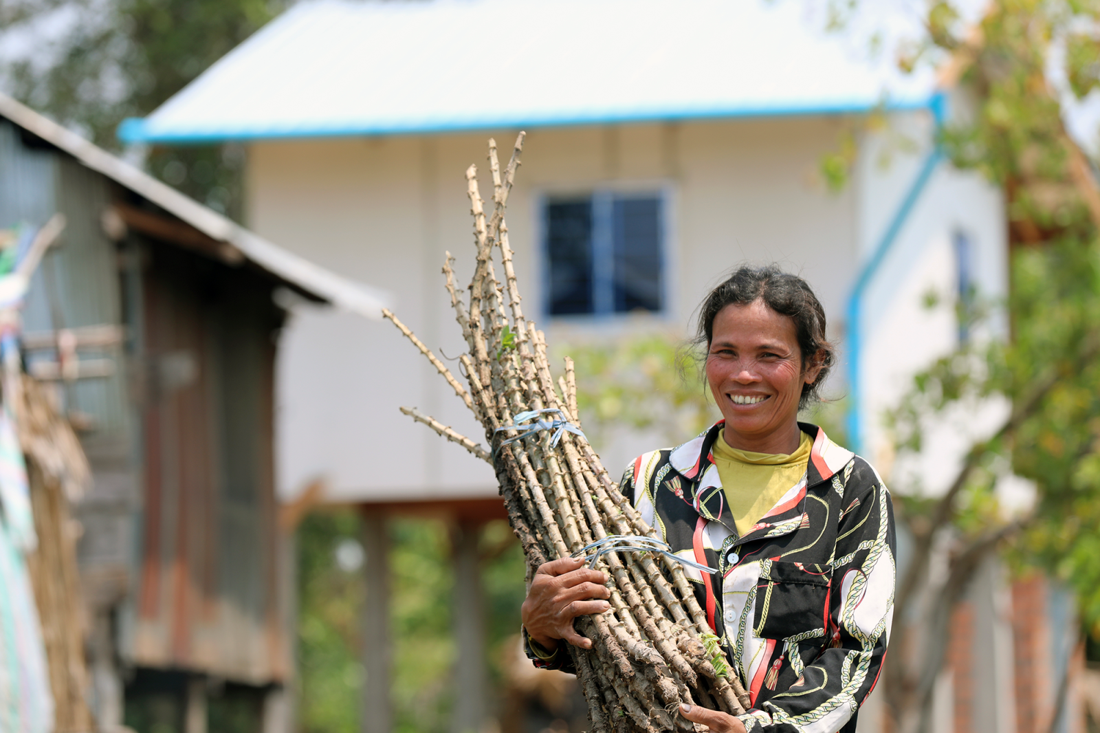 Nhan shows off a recent harvest from her house farm in Siem Reap, Cambodia.
