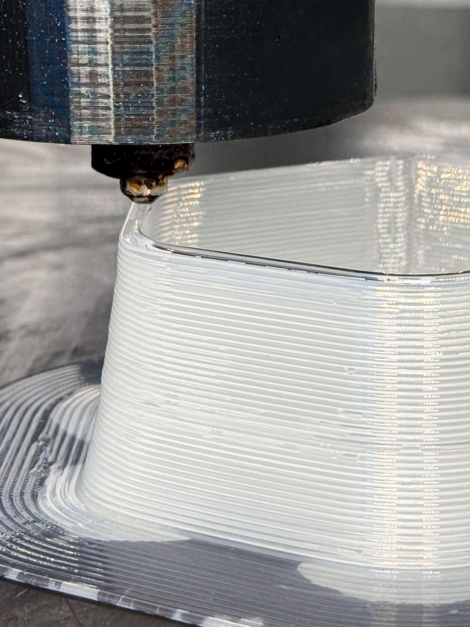 3D printer creating a white lampshade. 