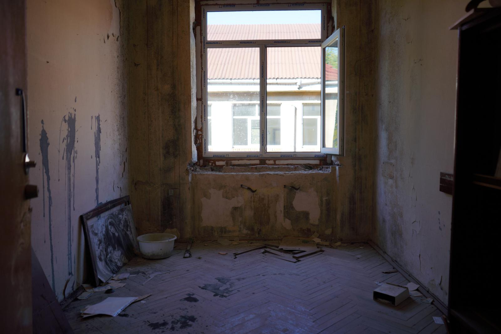 A Ukraine apartment before renovation. The walls and floor look rough and there is no furniture.