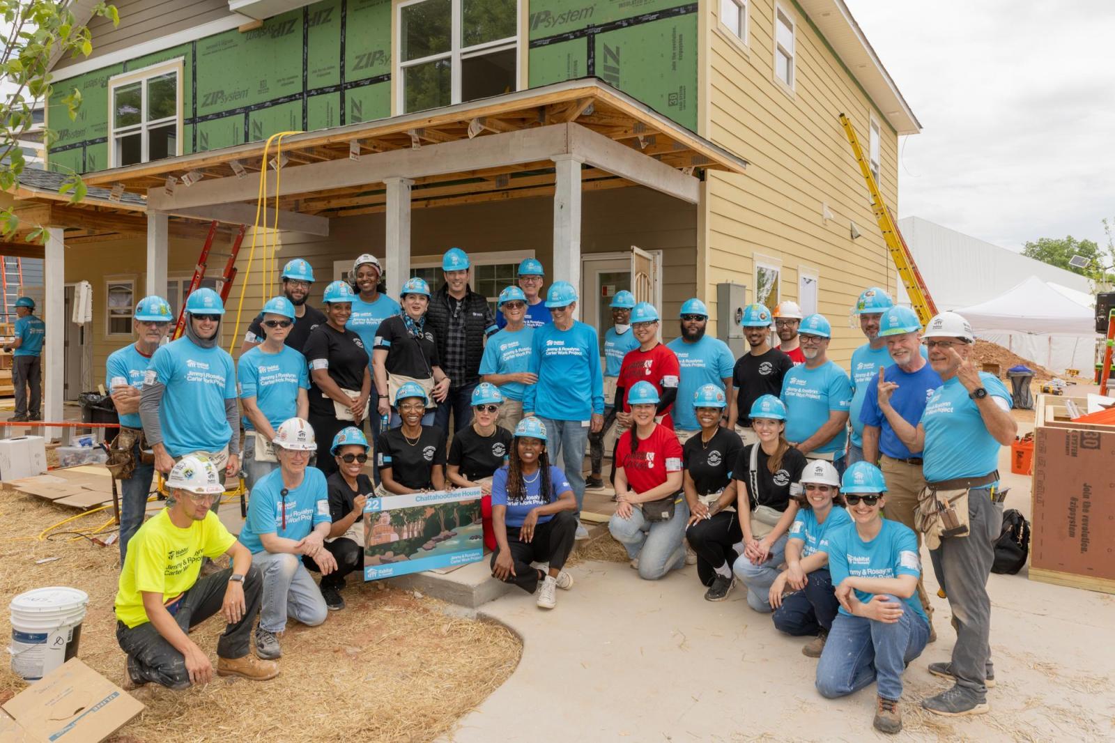 House 22 volunteers posing as group in front of house.