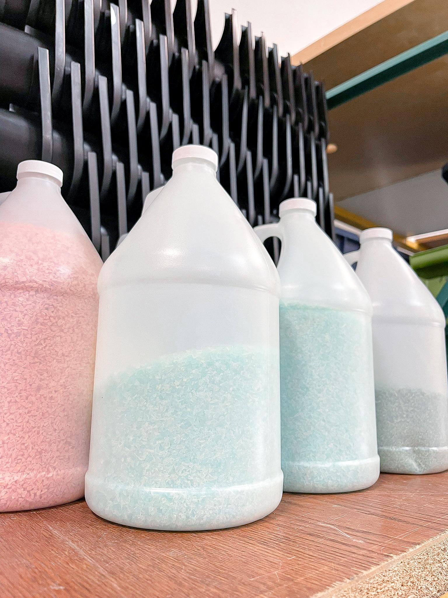 Small recycled plastic bits in jug containers.