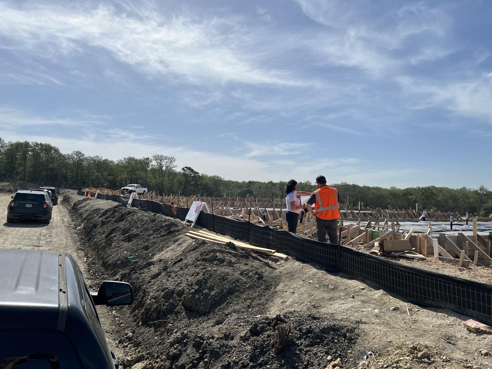 Staff and vehicles on the build site.