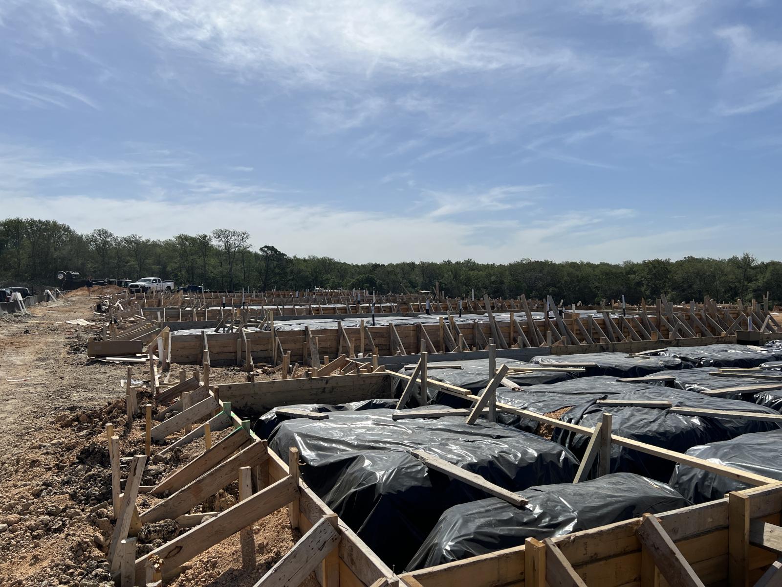 Wooden concrete forms under construction for the foundations of future Habitat homes.