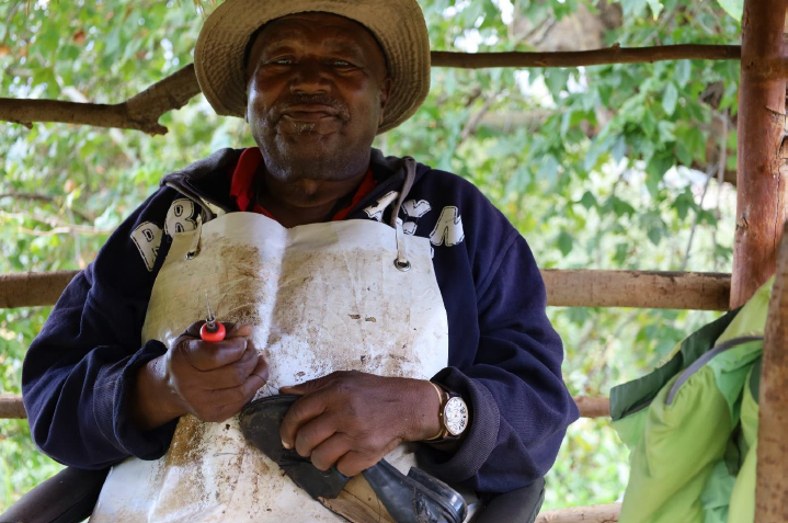 Man in apron sitting on porch