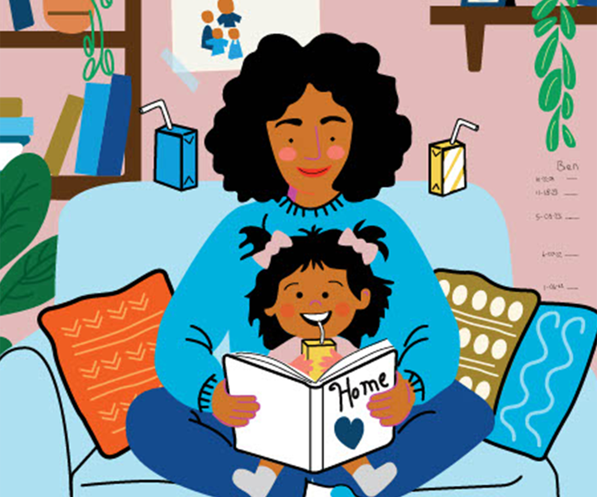 A woman sits in a chair reading to a child.