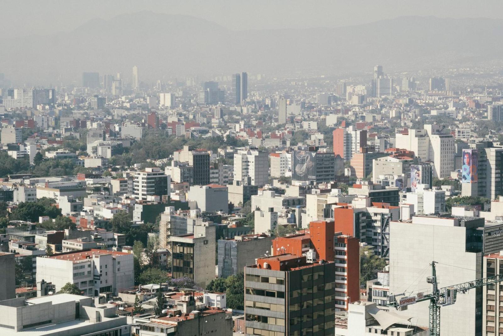 A wide shot of Mexico City buildings and streets. 