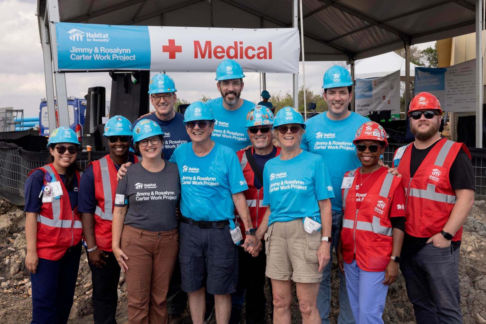 First aid volunteers stand in a group smiling at Carter Work Project in Austin, Texas.