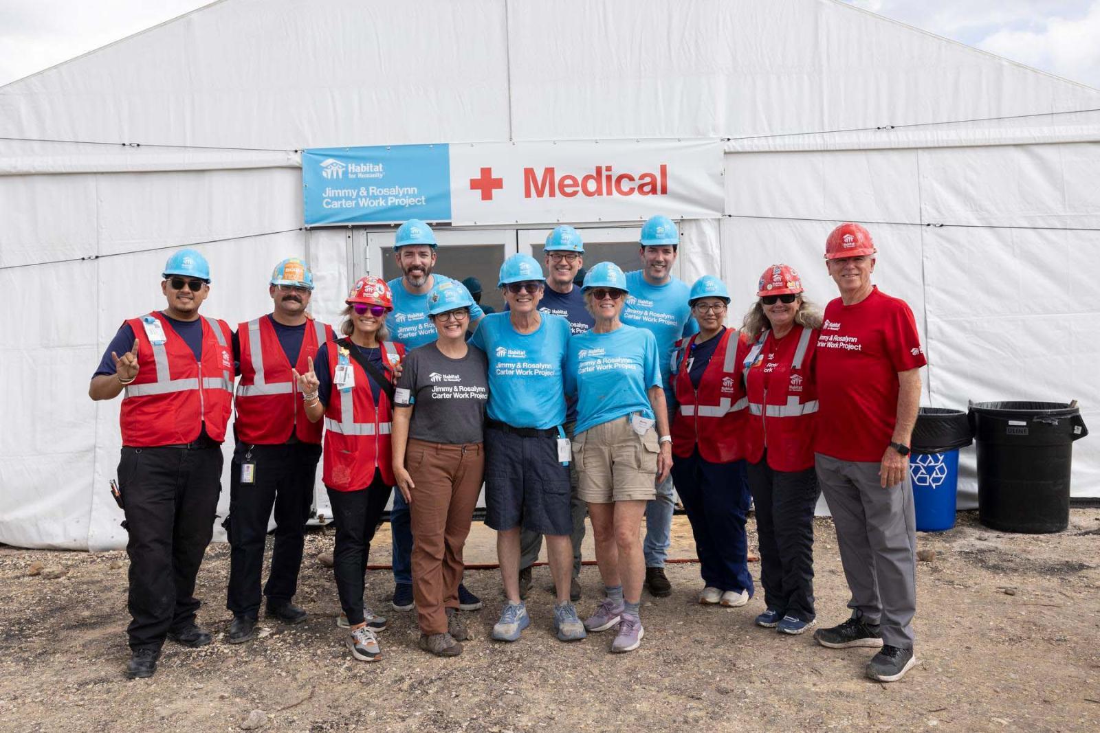 First aid volunteers stand in a group smiling at the camera at Carter Work Project in Austin, Texas.