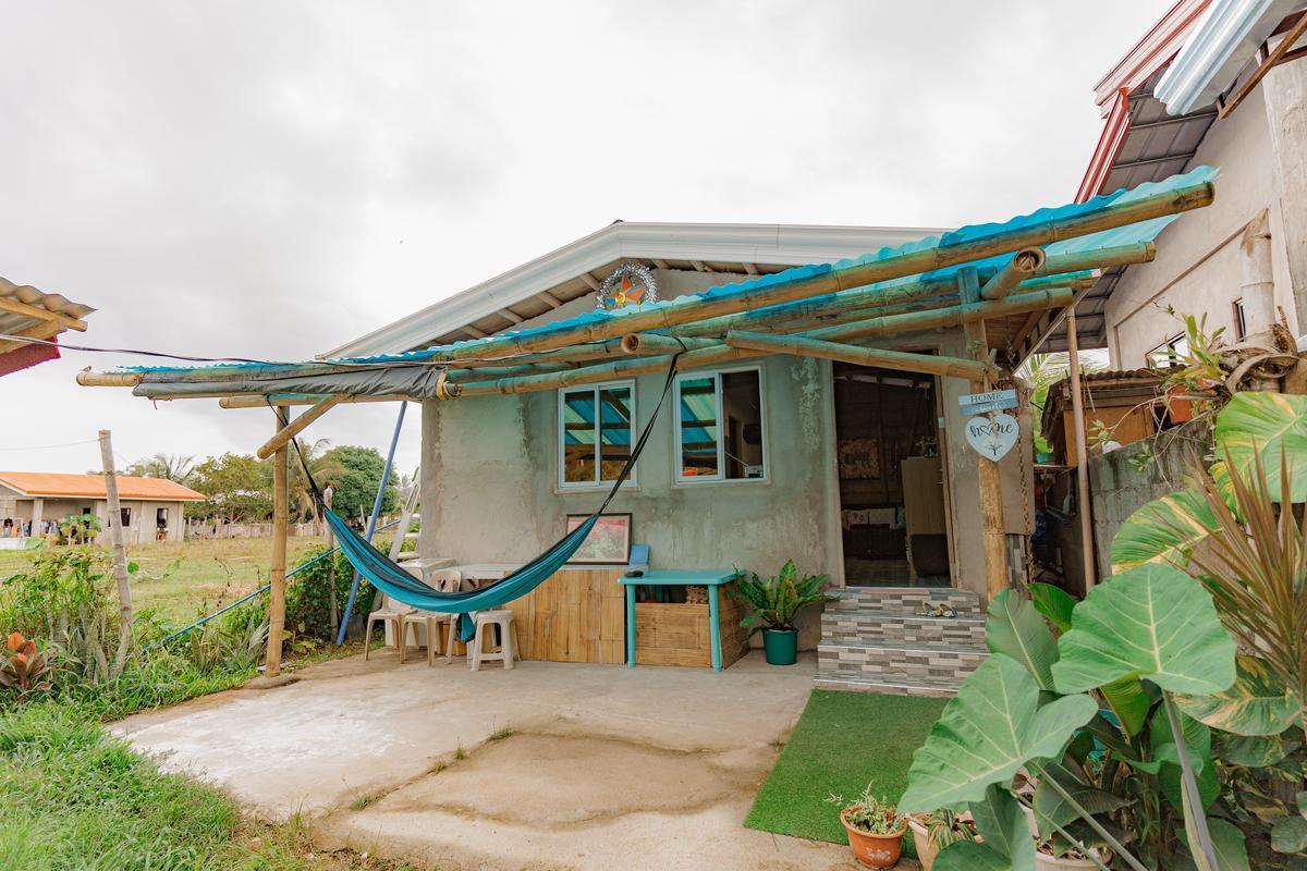 Exterior of a starter home kit by Kawayan Collective in Dauin with blue hammock.
