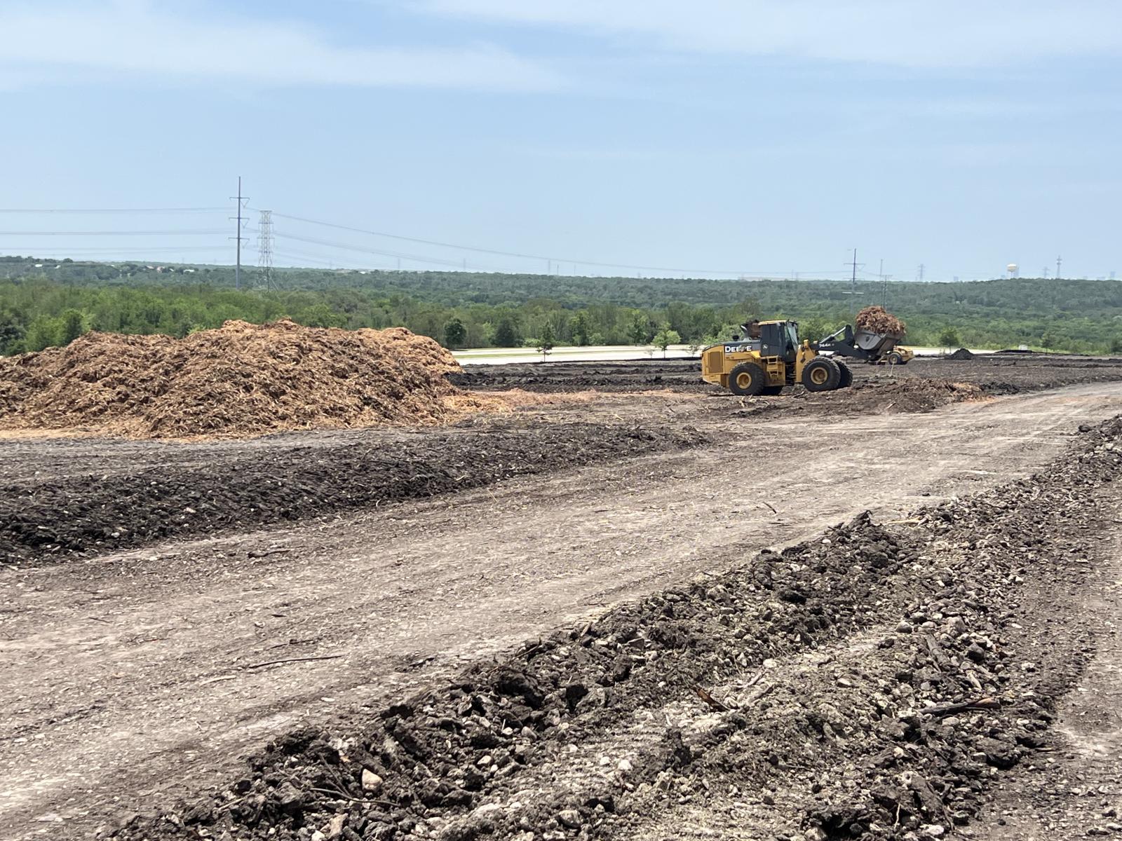 Piles of dirt and a dirt road. 