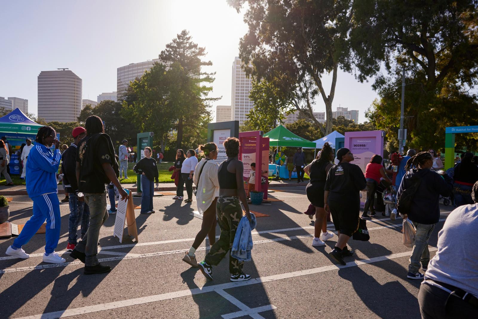 A group of people moving through the Let's Open the Door exhibit in Oakland.